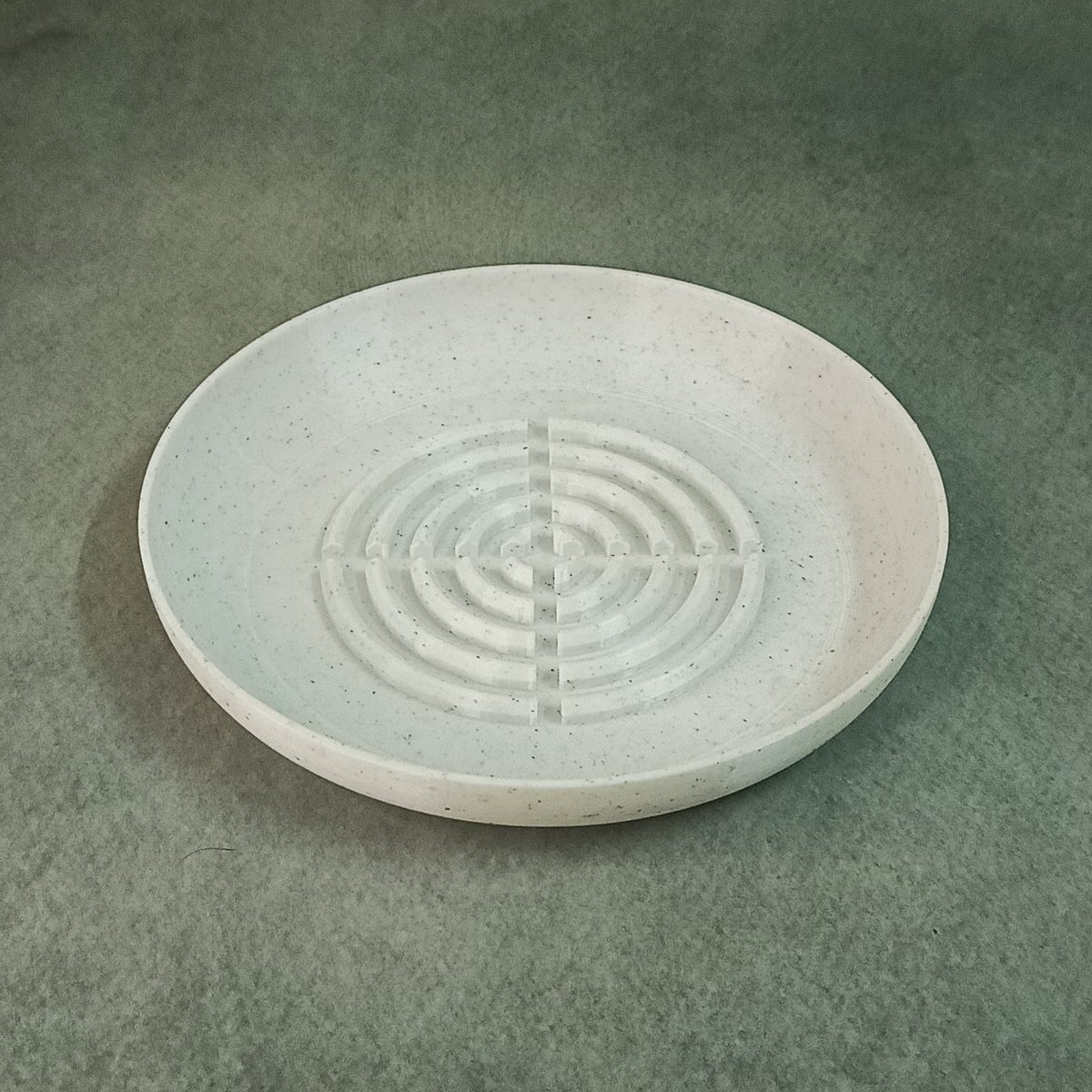 Round 3D printed flower pot base plate used as a water draining tray